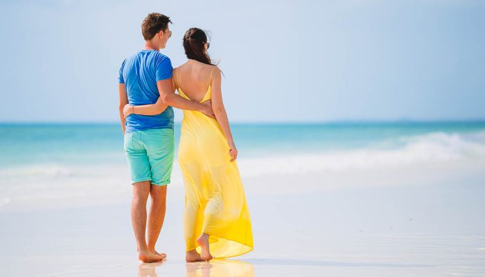 Young family on white beach during summer vacation